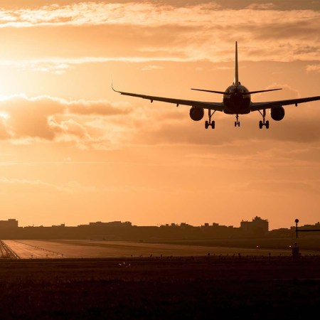 An airplane flying at dusk