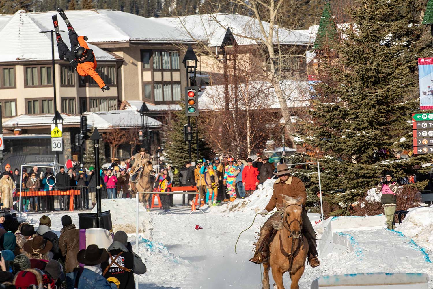 A skier in the air, being pulled by a horse