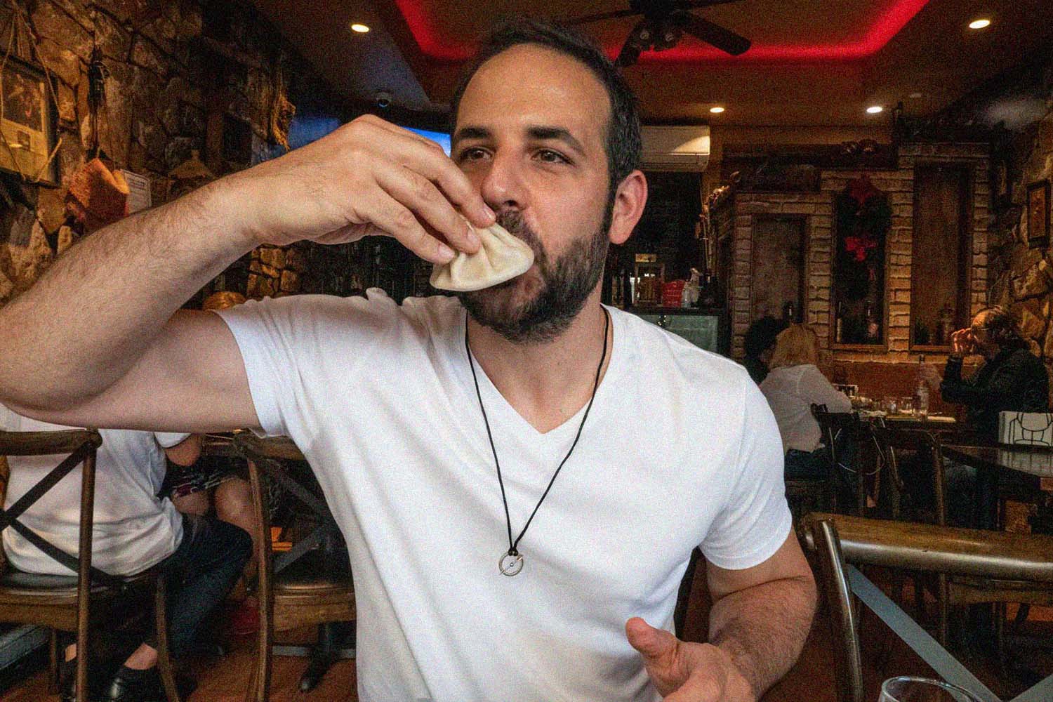 The author eating khinkali at Toné Café