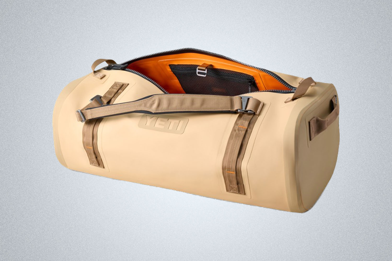 a tan Yeti duffle on a grey background