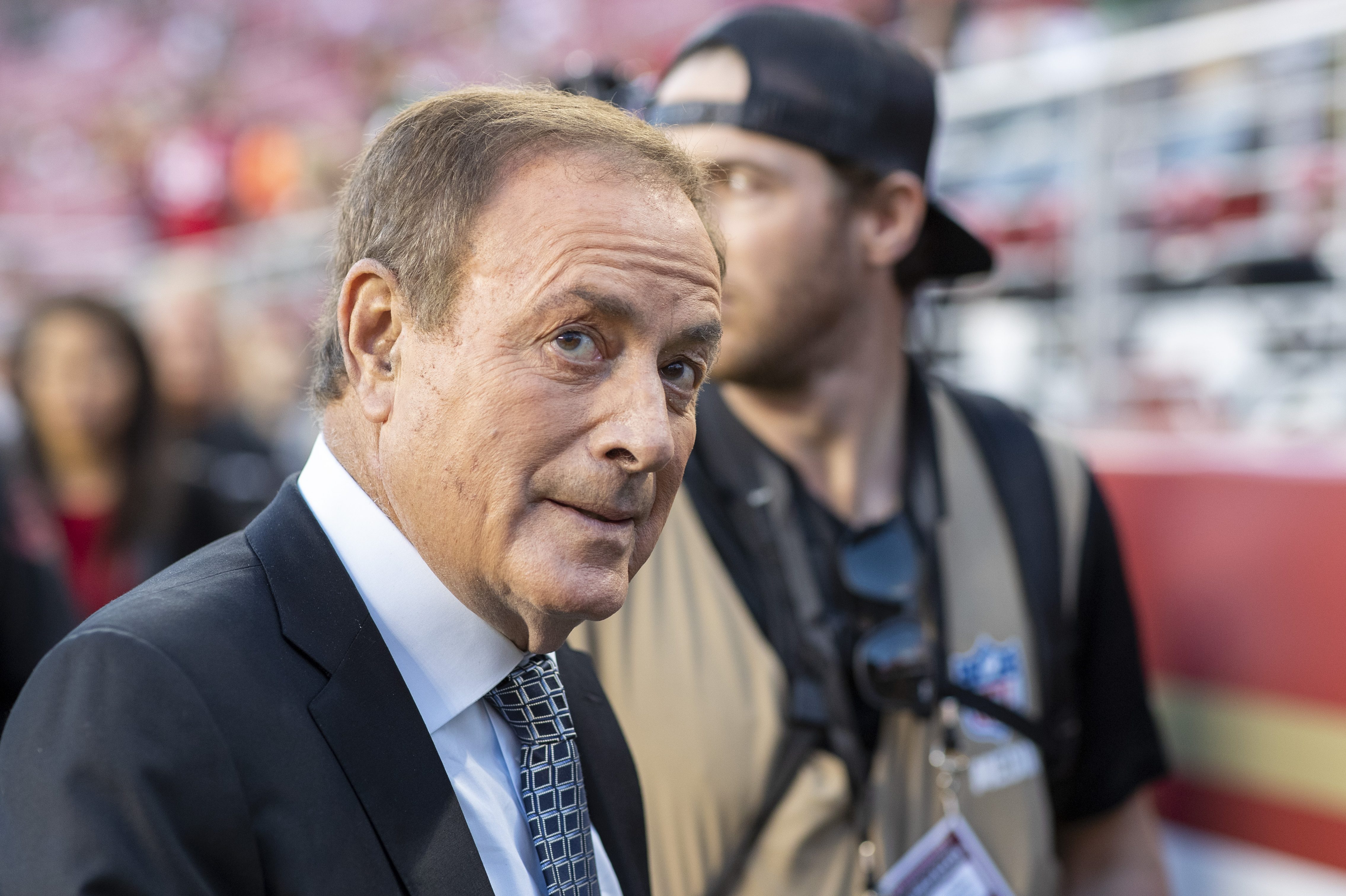 Al Michaels on the field during an NFL game.