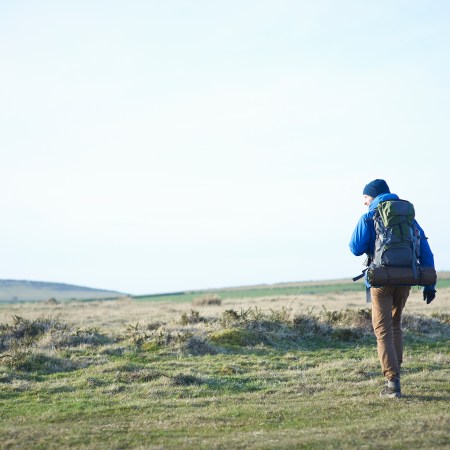 A backpacker in an open field.