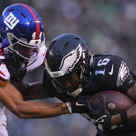 Quez Watkins runs with the ball against Nick McCloud.