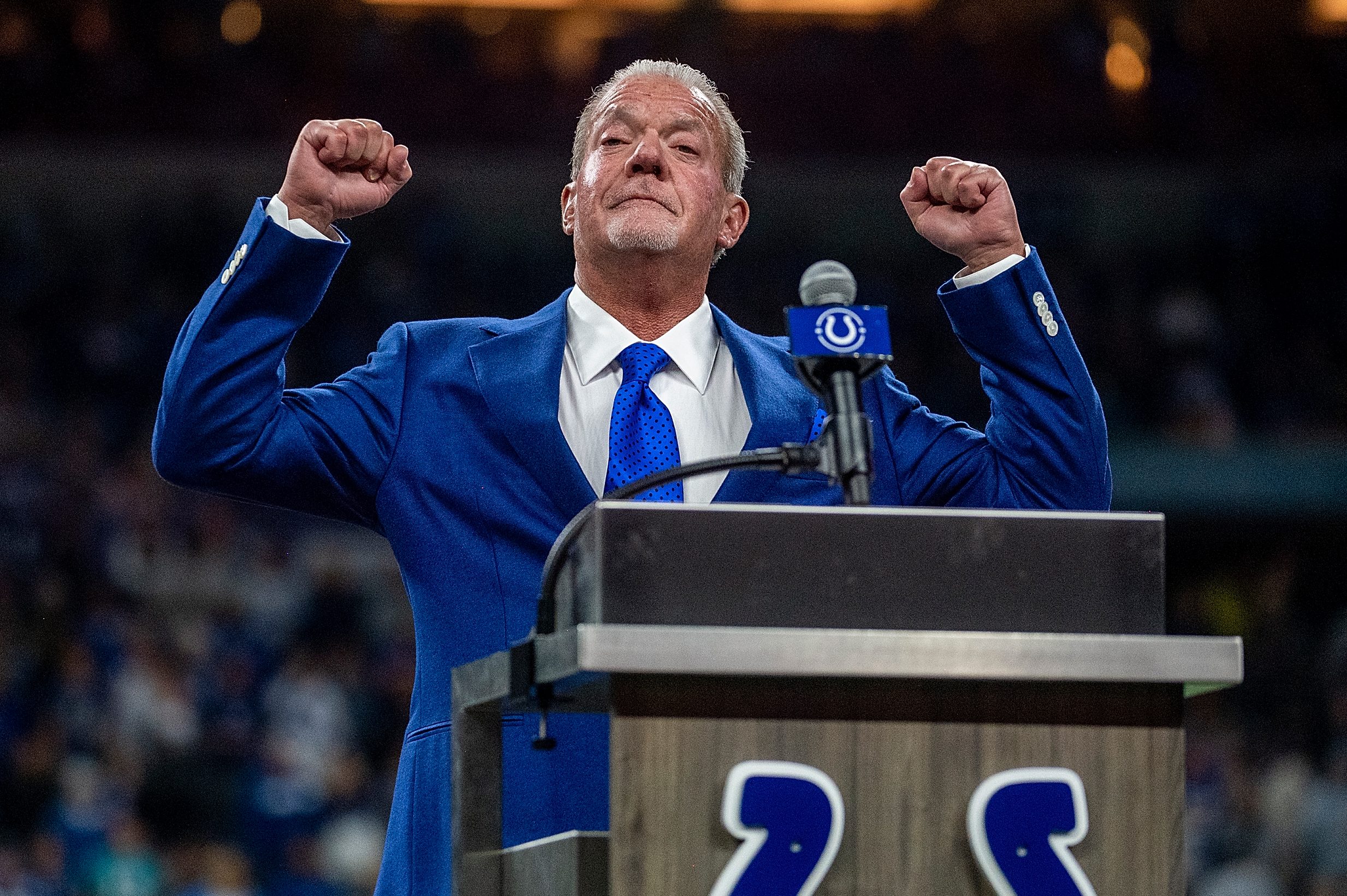 Indianapolis Colts owner Jim Irsay on stage in a blue suit and blue tie