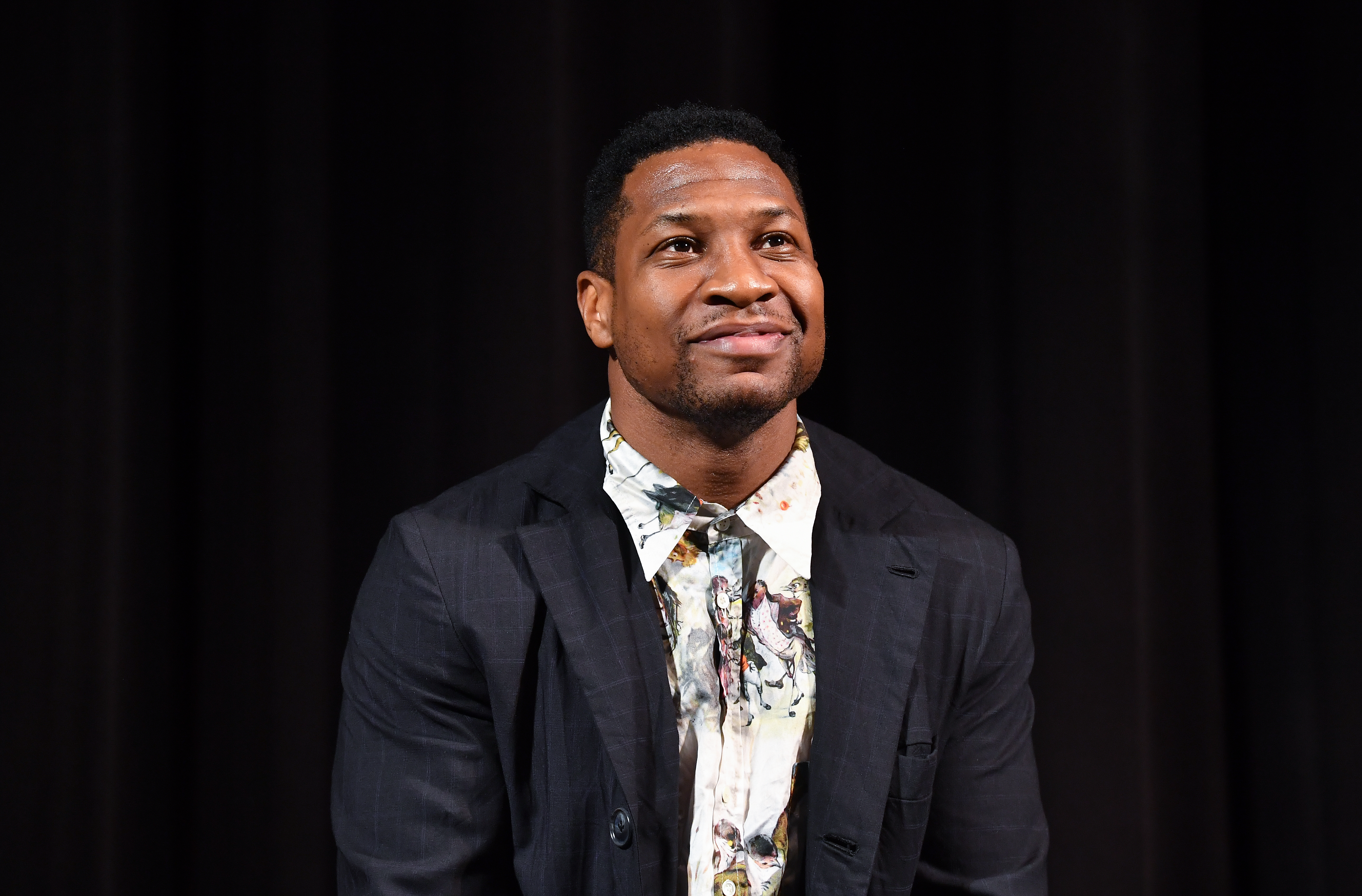 A photo of Jonathan Majors against a black background.