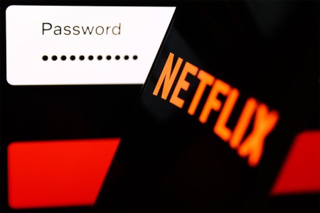 Netflix sign-in page displayed on a laptop screen and Netflix logo displayed on a phone screen are seen in this illustration photo. The streaming service plans to crack down on password sharing on a larger scale.