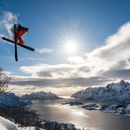 Skier Adam Ü jumping off a cliff in Norway's Lofoten Islands