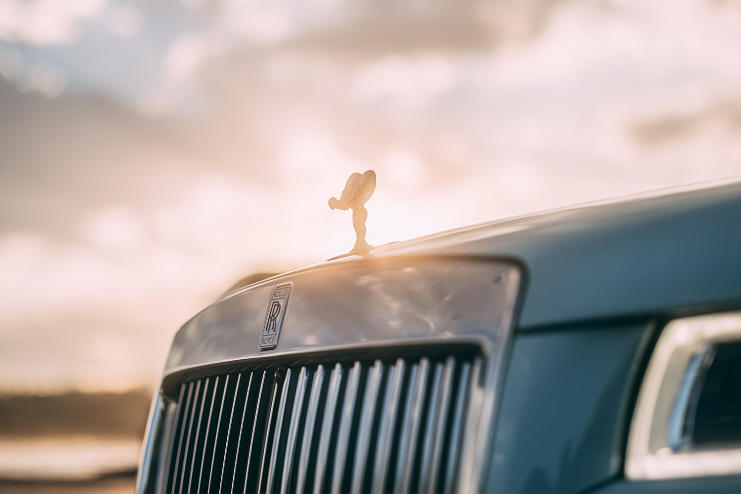 A Rolls-Royce Ghost that's part of the automaker's Pebble Beach Collection, zoomed in on the Spirit of Ecstasy, the brand's mascot