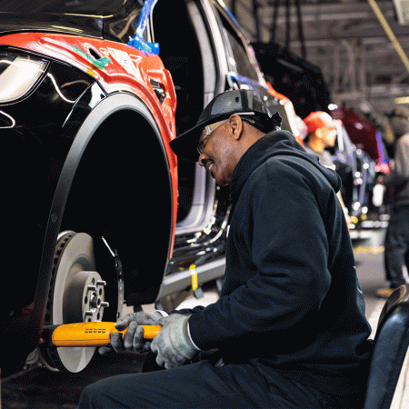 A Tesla factory worker in the EV company's Fremont, California factory. Elon Musk's company just became the luxury sales leader in the U.S. in 2022.