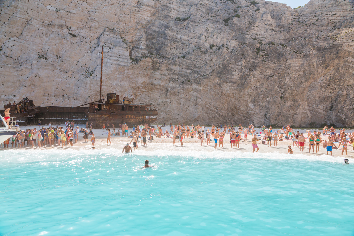 crowds of people at shipwreck beach in Zakynthos, Greek Islands