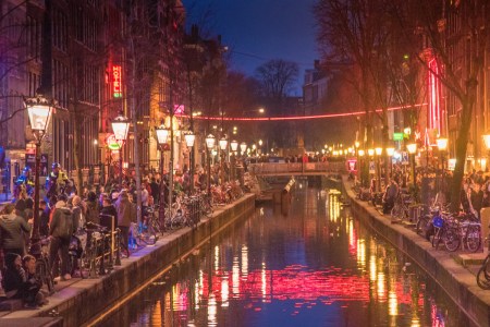 Red light destrict view and Amsterdam canal, bicycles and cyclists