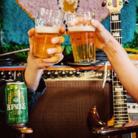 two people cheering pints of hopnosis beer