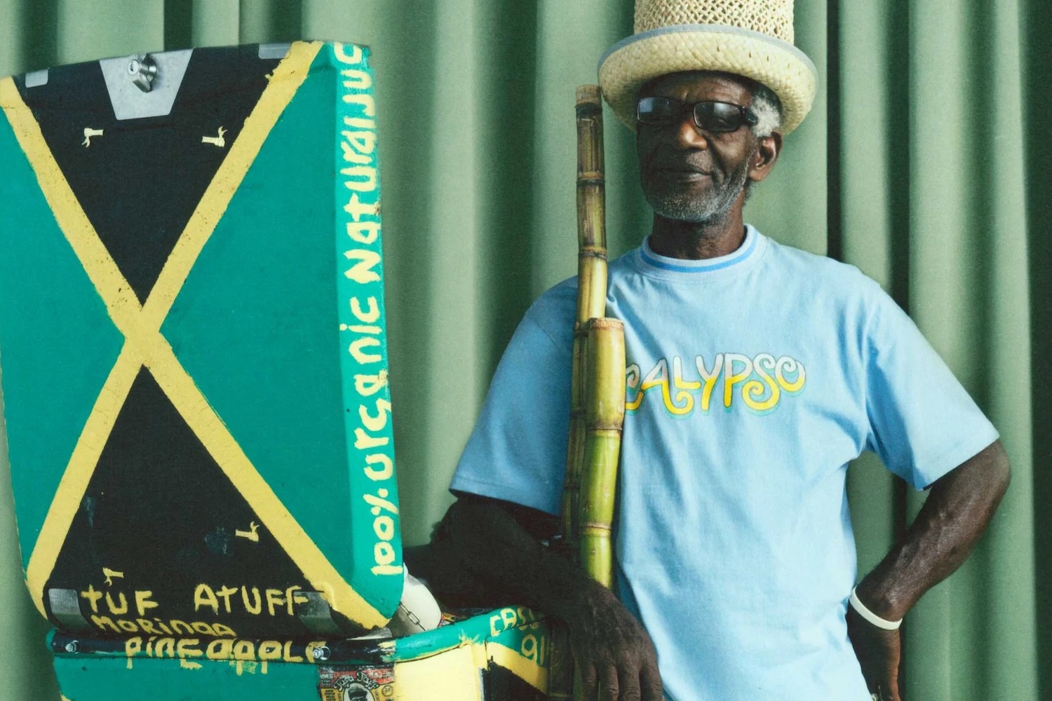 a model in Nicholas Daley clothing next to a suitcase