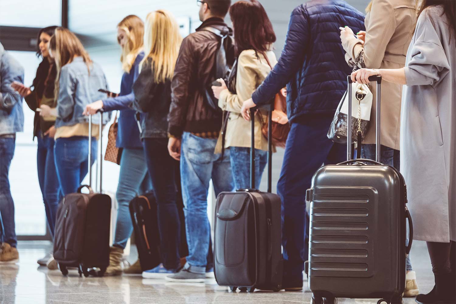 Passengers standing in a queue at airport