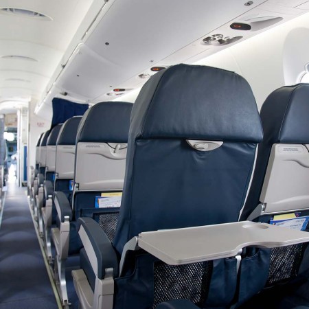 Rows of airplane seats, which, according to CNN, are slowly starting to lose the reclining function