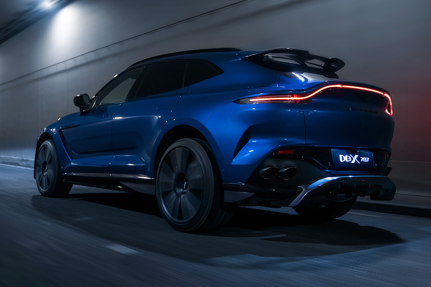 Aston Martin's DBX707 driving at night through a tunnel