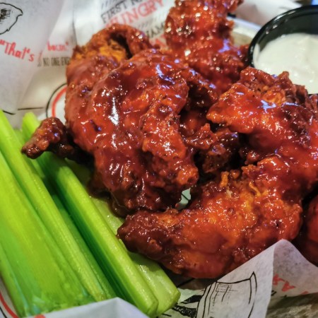 A plate of celery and boneless wings, which some people argue aren't "wings" or "boneless"