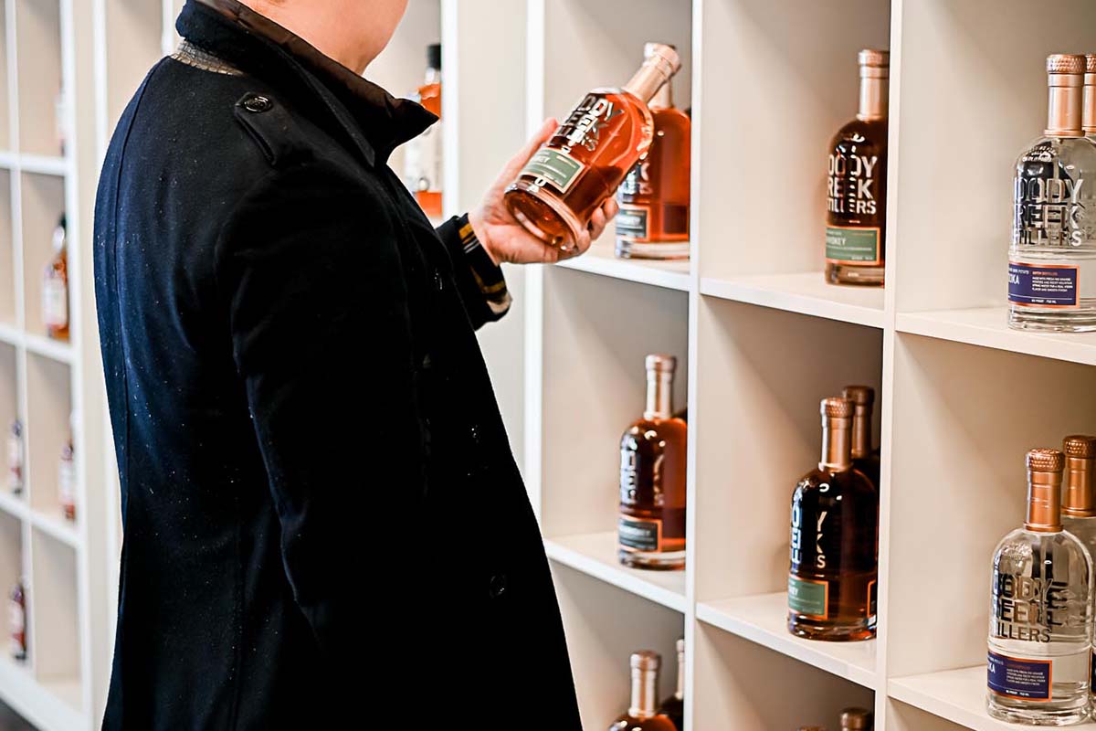 A customer in the BOTLD store in Philadelphia looking at a craft spirit. The store uses a loophole to get difficult-to-find spirits into the state.