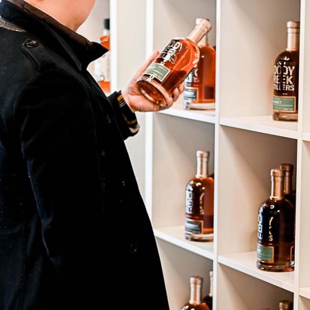 A customer in the BOTLD store in Philadelphia looking at a craft spirit. The store uses a loophole to get difficult-to-find spirits into the state.