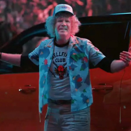 Will Ferrell, dressed as Dustin Henderson from "Stranger Things," stands in front of a Chevrolet Silverado EV Trail Boss in a Super Bowl ad from GM and Netflix