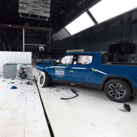 A blue Rivian R1T after a crash test at the Insurance Institute for Highway Safety