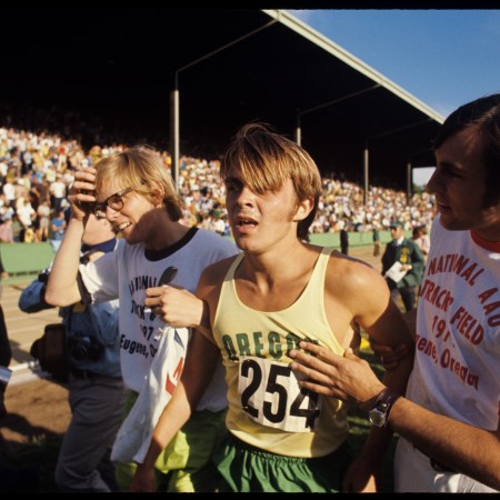 Steve Prefontaine tired after finishing a race, in his Oregon track jersey.