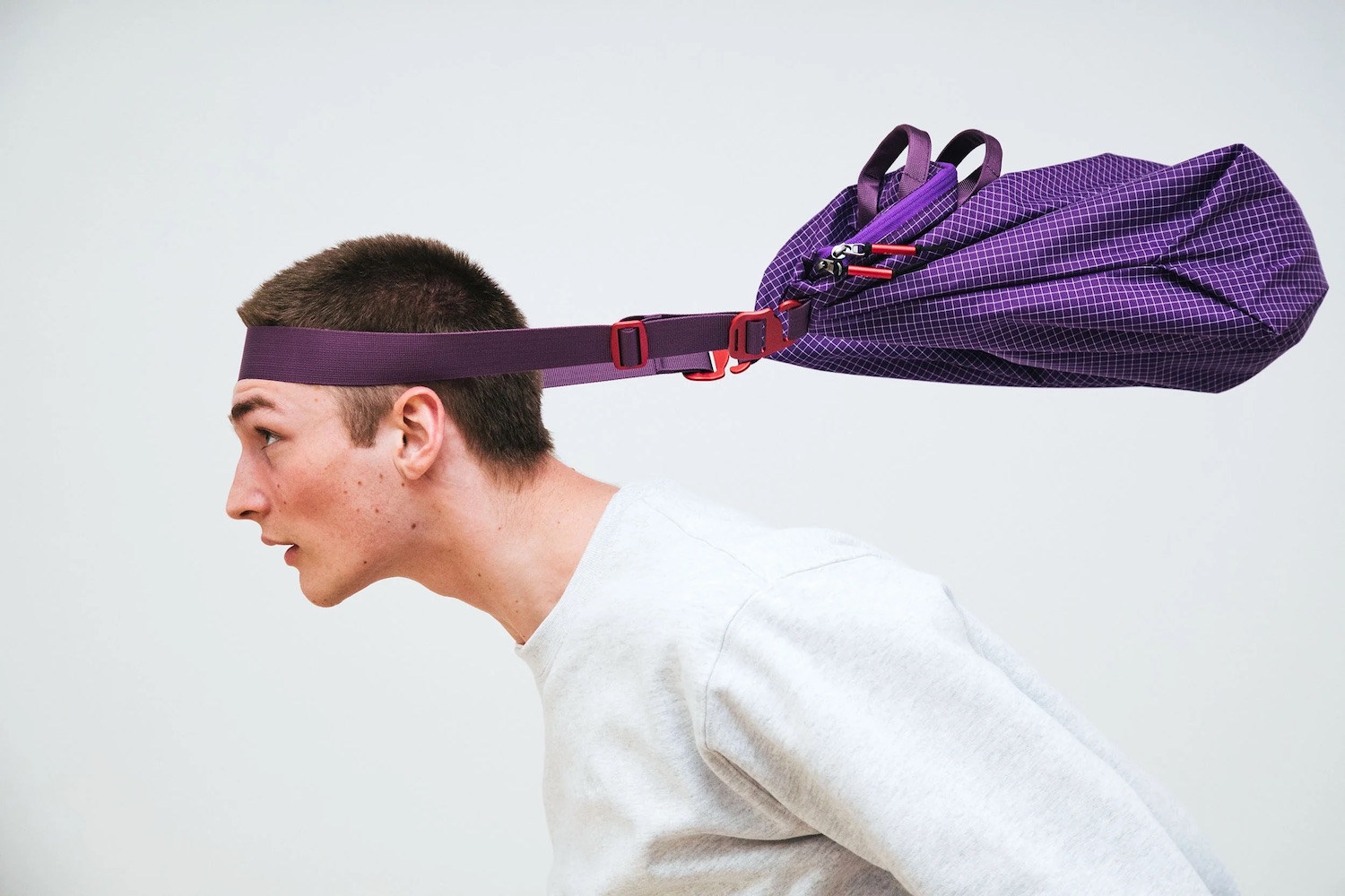 a model in Adsum clothing with a tote bag around his forehead