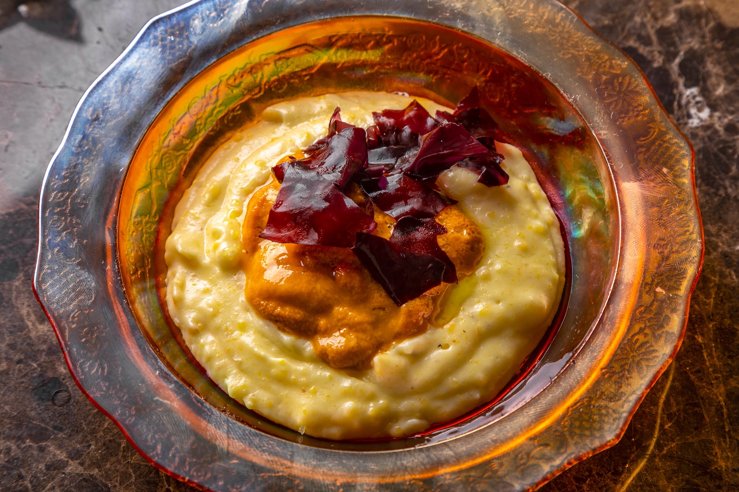 Polenta with Maine sea urchin in an orange carnival glass bowl