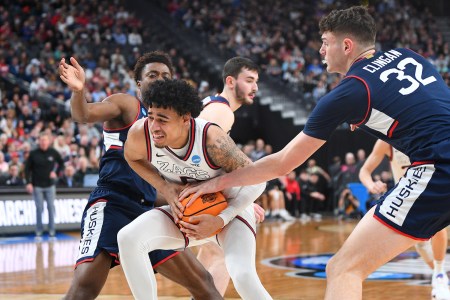 Gonzaga guard Julian Strawther (0) is tied up by UConn Huskies center Donovan Clingan (32) during the NCAA Division I Men's Championship Elite Eight round basketball game between the Gonzaga Bulldogs and the UConn Huskies on March 25, 2023 at T-Mobile Arena in Las Vegas, NV.