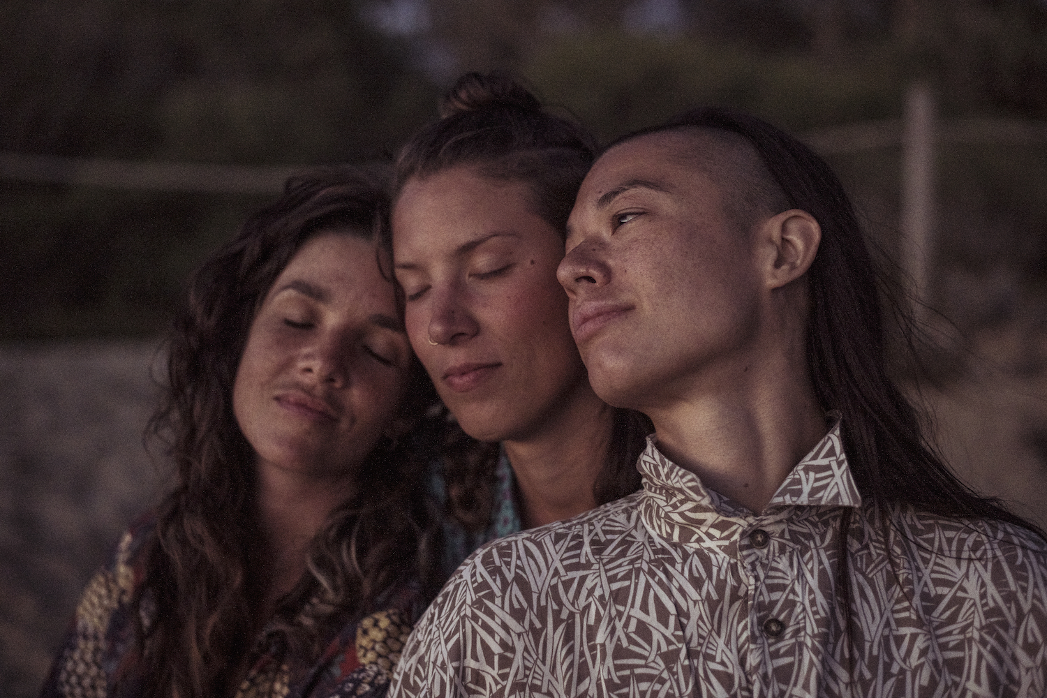 Queer female thrupple celebrating polyamory relax peacefully together at dusk