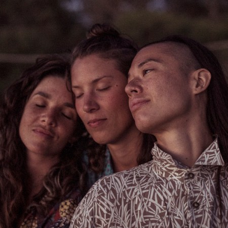 Queer female thrupple celebrating polyamory relax peacefully together at dusk