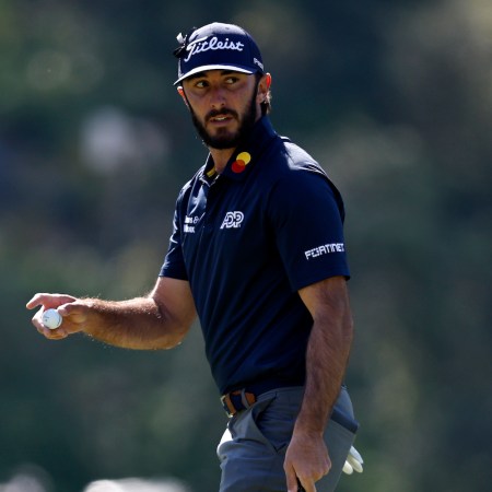 Max Homa walks a course holding his golf ball