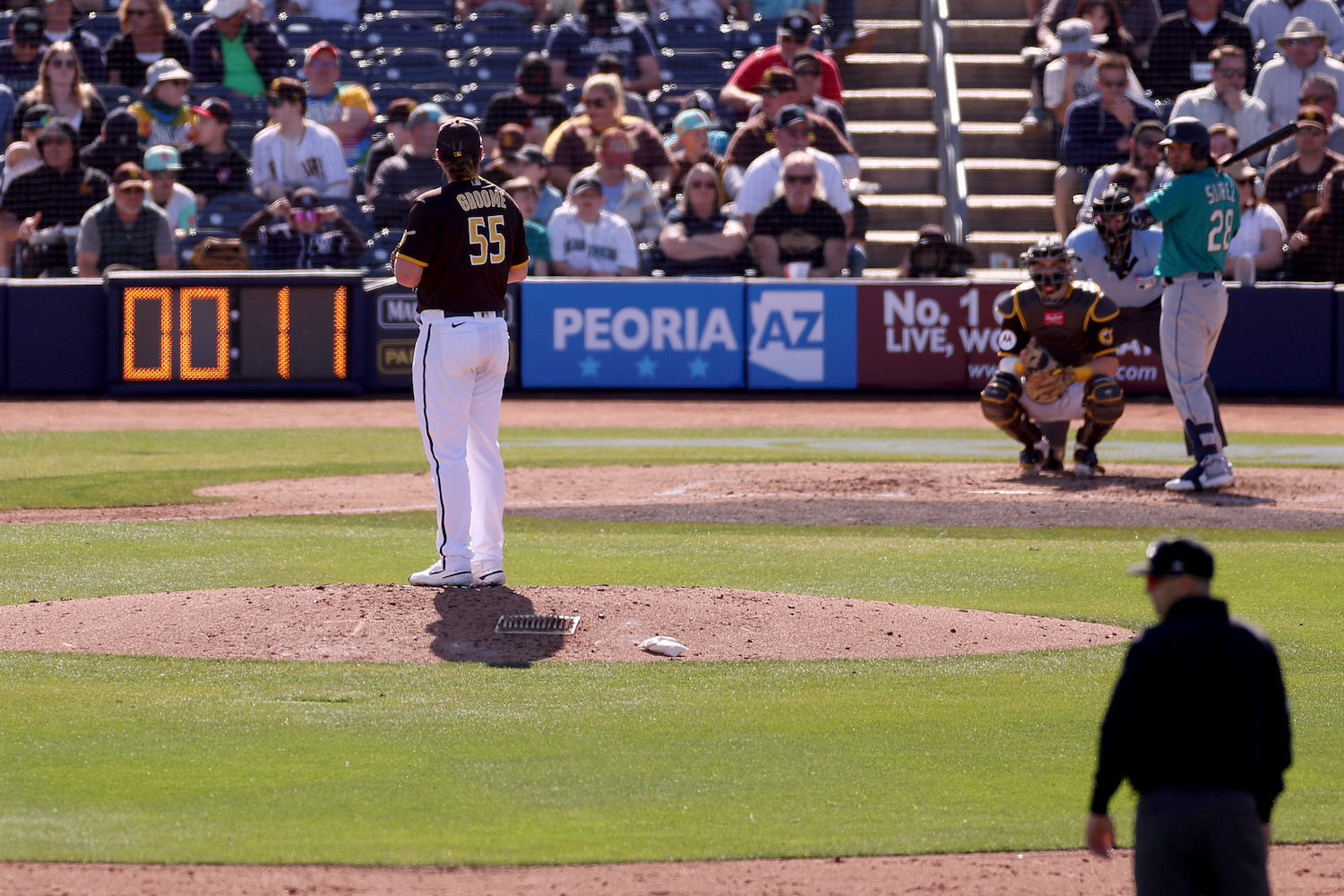 A pitch clock counts down as Jay Groome #55 of the San Diego Padres prepares to deliver a pitch to Eugenio Suarez #28 of the Seattle Mariners during the sixth inning in a spring training game at Peoria Stadium on February 24, 2023 in Peoria, Arizona.