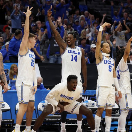 The UCLA Bruins celebrates a three point basket during the second half of a game against the North Carolina-Asheville Bulldogs in the first round of the NCAA Men's Basketball Tournament at Golden 1 Center on March 16, 2023 in Sacramento, California.