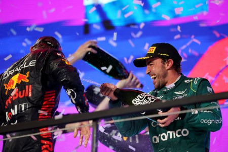 Second placed Max Verstappen of the Netherlands and Oracle Red Bull Racing and Third placed Fernando Alonso of Spain and Aston Martin F1 Team celebrate on the podium during the F1 Grand Prix of Saudi Arabia at Jeddah Corniche Circuit on March 19, 2023 in Jeddah, Saudi Arabia.