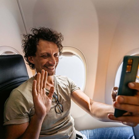 A passenger FaceTiming on an airplane inflight