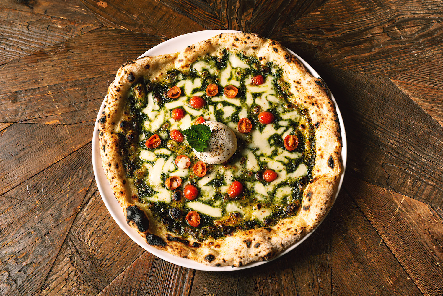 pesto pizza on a wooden table at nyc's L'Antica Pizzeria da Michele