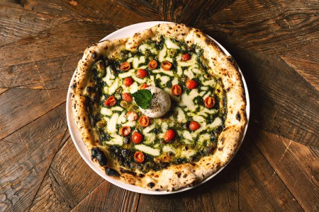 pesto pizza on a wooden table at nyc's L'Antica Pizzeria da Michele