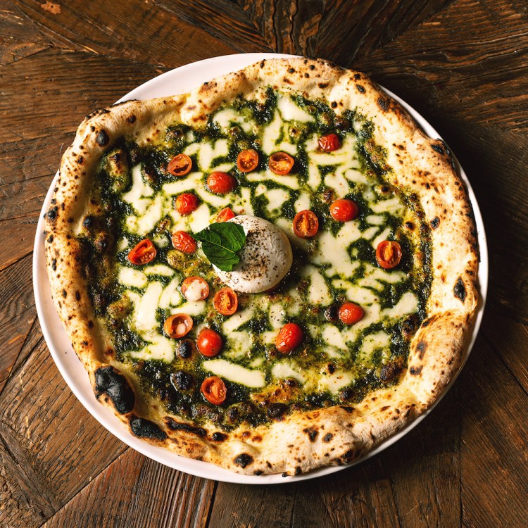 pesto pizza on a wooden table at nyc's L'Antica Pizzeria da Michele