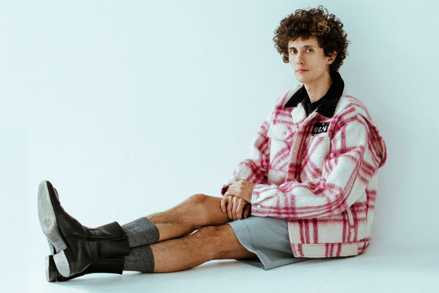 Ron Gallo wearing PHIPPS Chore Coat, Canali Shorts, and Squared Boots.