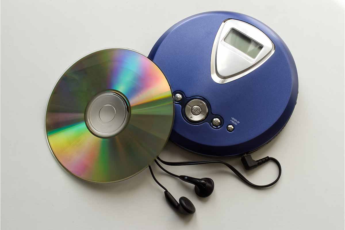 An old CD player with headphones isolated on white background. CDs launched in the U.S. on March 2, 1983, 40 years ago this week.