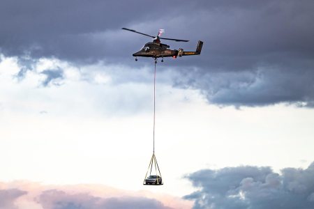 A helicopter carries the 2023 Dodge Challenger SRT Demon 170 to the Las Vegas Motor Speedway