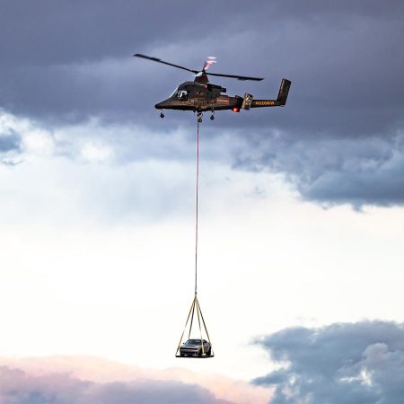 A helicopter carries the 2023 Dodge Challenger SRT Demon 170 to the Las Vegas Motor Speedway