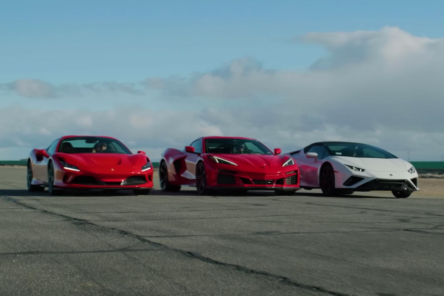 A 2024 Chevrolet Corvette E-Ray hybrid in a drag race against a Ferrari F8 Spider and Lamborghini Huracan Evo RWD Spyder