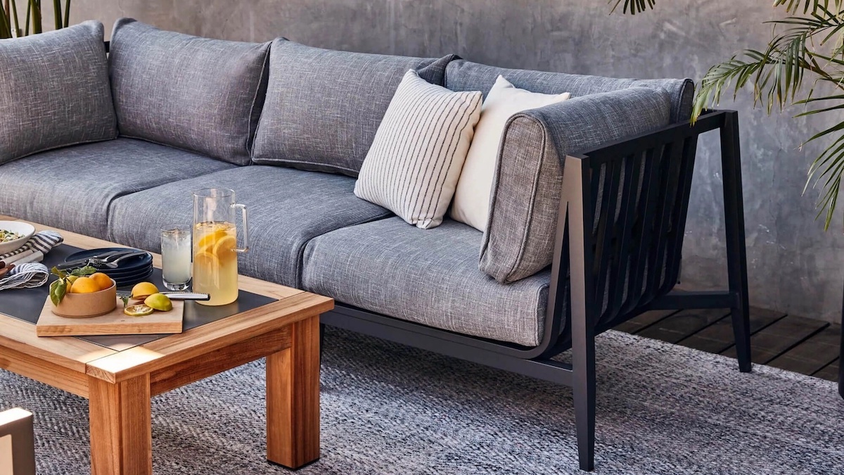 an grey Outer couch and wooden coffee table on a patio