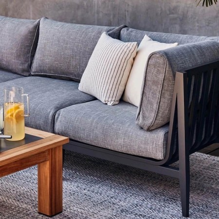 an grey Outer couch and wooden coffee table on a patio