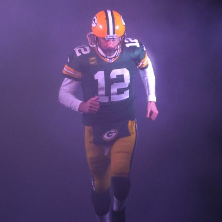 Aaron Rodgers takes the field for a game against the Detroit Lions.