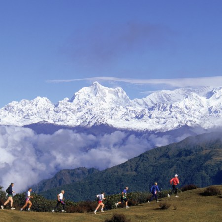 A line of people running in the mountains.