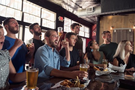 Group of friends watching game in bar