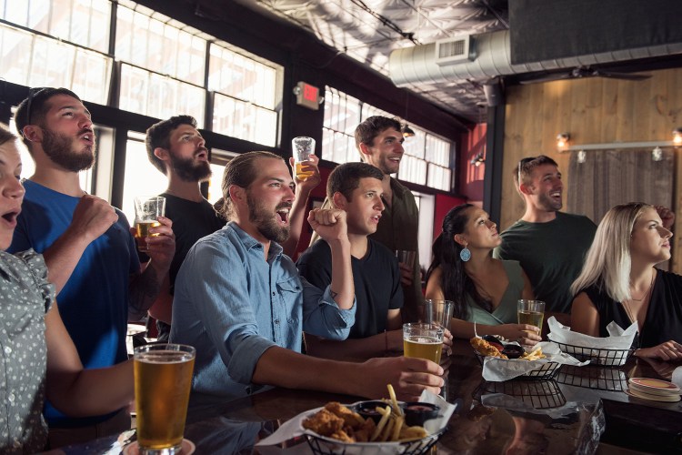 Group of friends watching game in bar